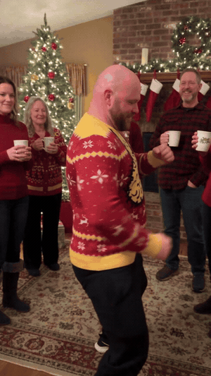 Man dancing in the Hairy Xmas Sweater at a Christmas party